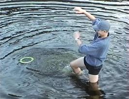 Tom does some strange moves to retrieve the frisbee from the River Lledr opposite the youth hostel